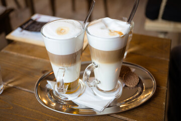 Morning coffee break - glass of latte macchiato and wiener melange coffee