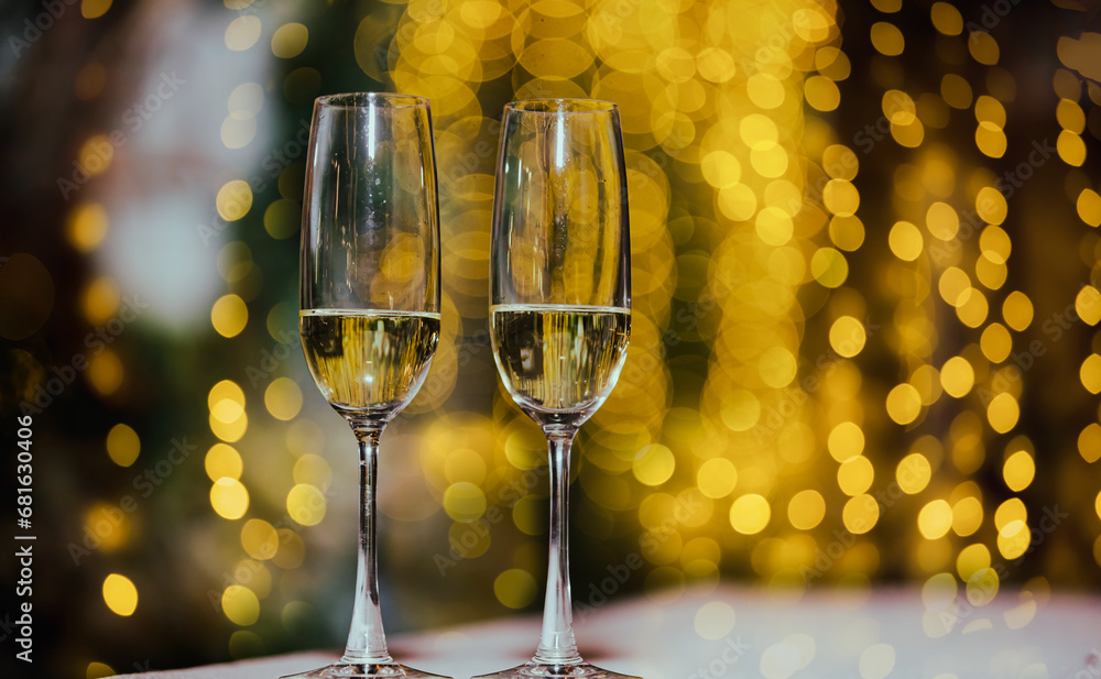 Wall mural a glass of champagne on table with blur light in restaurant.