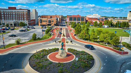 Passing of the Buffalo statue with Canan Commons Park aerial of city on gorgeous day, Muncie IN