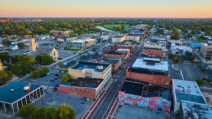 Colorful mural on building wall on S Walnut St with city aerial, Muncie, Indiana at dawn