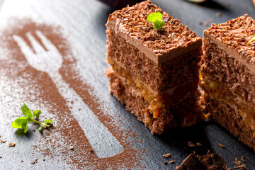 Chocolate cake cut into square pieces with nut cream