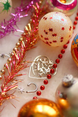 Colorful vintage Christmas ornaments and white faux fur blanket. Cute and kitschy Christmas decorations. Selective focus.