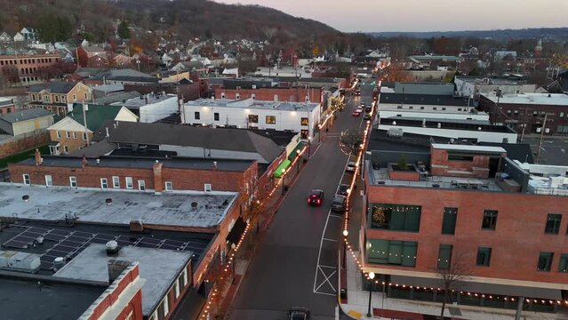 SEWICKLEY, PA - November 19, 2023 - A high angle aerial establishing shot of a small New England town decorated for Christmas. Pittsburgh suburbs.  	