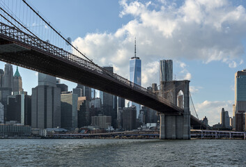 brooklyn bridge view over hudson river with nyc skyline background (urban cityscape of manhattan)...
