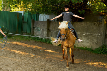 Portrait of teenage girl  on horseback wearing
