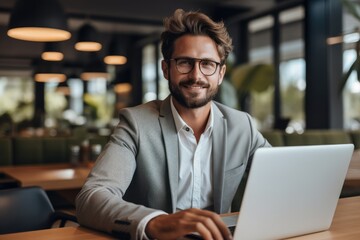 Marketing manager sitting in a stylish modern office space, He looks empowered and composed.