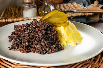 Fried black pudding with mashed potatoes.