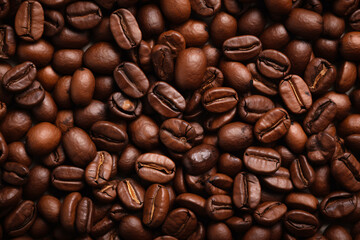 Obraz premium A close-up of toasted coffee beans in the foreground.