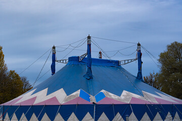 Blue roof of a circus tent with its typical roof construction in the evening. 