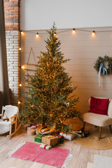 Modern Christmas tree with lots of lights and minimalist decoration in the Scandinavian living room