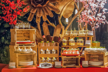 Chinese New Year buffet dinner set up catering with ornaments, citrus fruits, decorated with...