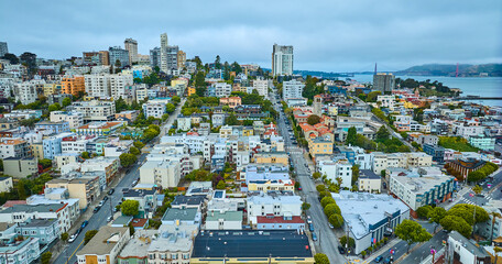 San Francisco apartment buildings aerial wide view of city streets with Golden Gate Bridge in...