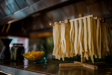 Noodle bar among catering banquet table. Variety of snacks, appetizers, seafood and cooked meals displayed as buffet for wedding, Christmas, business corporate, birthday party or other event