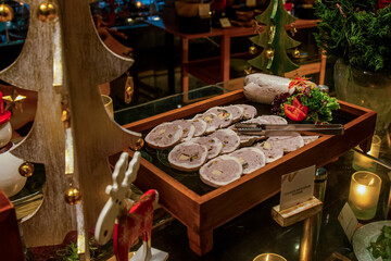Cold meat buffet bar among catering banquet table. Variety of snacks, appetizers, seafood and cooked meals displayed as buffet for wedding, Christmas, business corporate, birthday party or other event