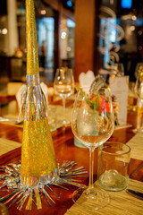 Christmas dinner table set up in restaurant with festive ornaments, decorations and tableware