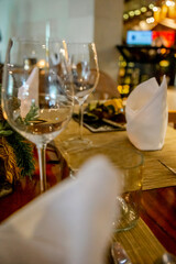 Christmas dinner table set up in restaurant with festive ornaments, decorations and tableware