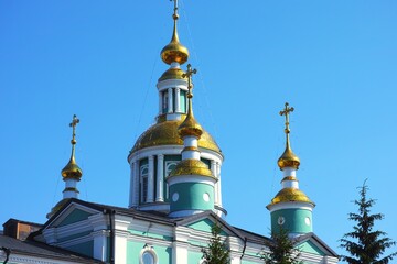 Fototapeta na wymiar The domes of an Orthodox church against the blue sky
