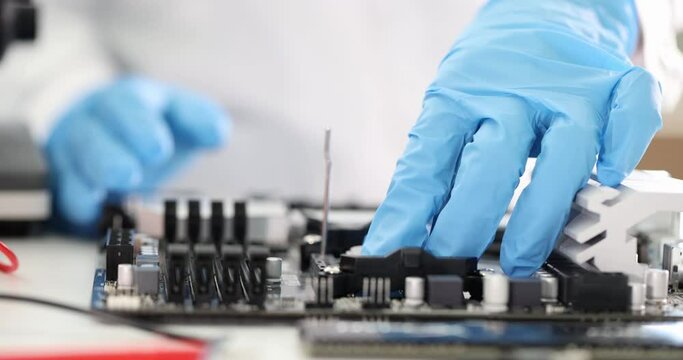Computer expert inserts microcircuit into computer motherboard. Computer diagnostics concept