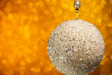 Spinning silver Christmas ball on bokeh background