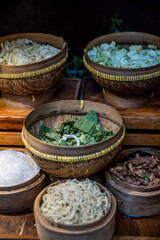 Noodle bar among catering banquet table. Variety of snacks, appetizers, seafood and cooked meals displayed as buffet for wedding, Christmas, business corporate, birthday party or other event
