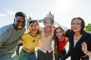 Multiracial group of happy young friends bonding in London city - Multiethnic teens students meeting and having fun in Tower Bridge area, UK - Concepts about youth lifestyle, travel and tourism