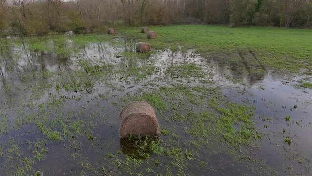 Flooded Farmland: Aerial Drone View of Hay Bales Submerged