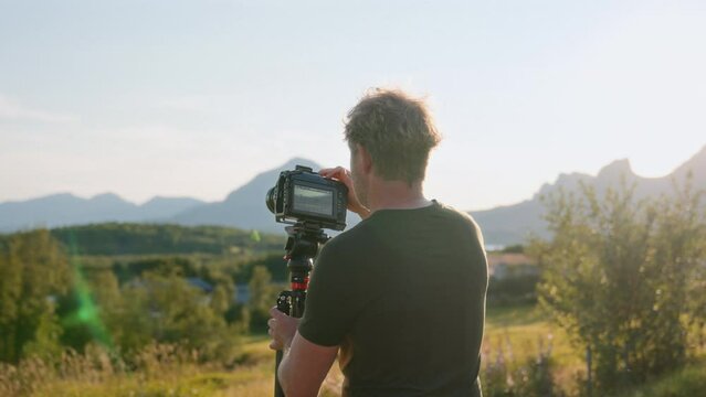 Filmmaker Preparing His Gear At Sunset