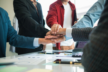 Businessmen and investors join hands symbolize friendship and cooperation in business success. concepts of group of businessmen and investors joining hands symbolize cooperation in doing business.