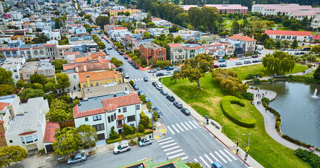 San Francisco aerial beside Palace of Fine Arts pond with people walking trail wide view of housing, CA