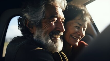 happy mature couple in the backseat of a car