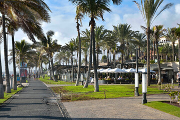 Tourists stroll on the Meloneras seafront in Gran Canaria, Canary Islands