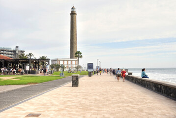 Tourists stroll on the Meloneras seafront in Gran Canaria, Canary Islands - 681696229
