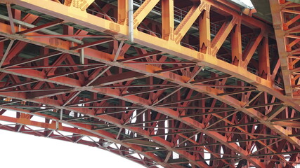 Curved orange steel bridge structure