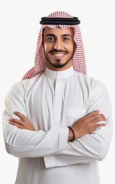 Young smiling Arabian Saudi man with arms crossed in front of white background