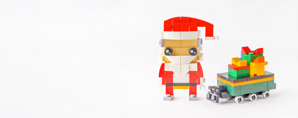 Merry Christmas Concept: Toy-Built Santa's Sleigh and Gifts Made from Bright plastic constructor. Banner. Copy space