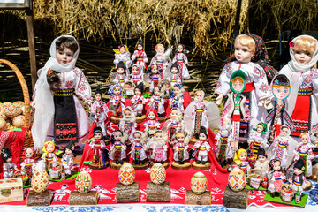 Group of colourful textile traditional hand made decorations, dolls and  toys for children, available for sale at a traditional weekend market in a village near Bucharest, Romania.