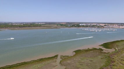 Fototapeta na wymiar Motor boats in the estuary with the sea in the background Aerial view marshes with many boats Spain