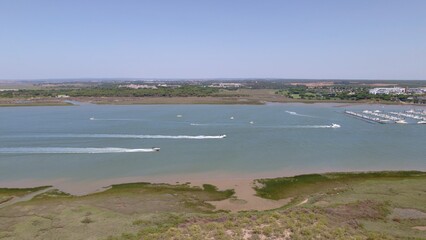 Motor boats in the estuary with the sea in the background Aerial view marshes with many boats Spain
