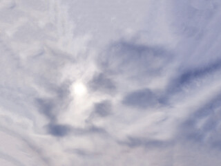 The sun is hidden behind thick clouds.