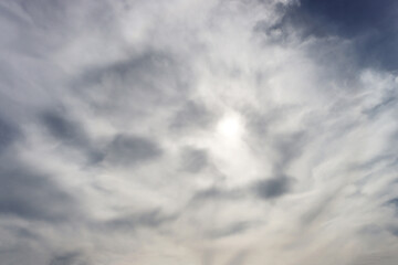The sun is hidden behind gray clouds.