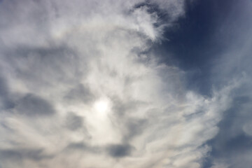 The sun is hidden behind thick clouds.