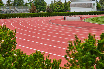 Red running track with empty lanes for runners sports at Ball State University, Muncie, Indiana