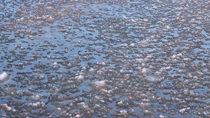 sea waves, ice slush illuminated by sunlight, abstract natural background
