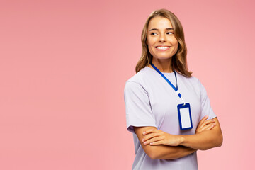 Beautiful smiling young woman, seller consultant wearing t shirt and blank badge looking away isolated on pink background, copy space. Name card, Mockup  - obrazy, fototapety, plakaty