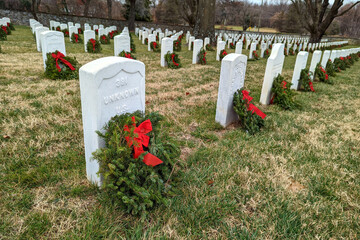 Christmas wreaths on the graves tombs of USA War Veterans in national cemetery, military