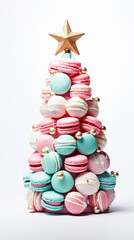 Sweet macaroons arranged in a Christmas tree with a star on the top isolated on white background. Colorful macarons dessert representing a Christmas tree.