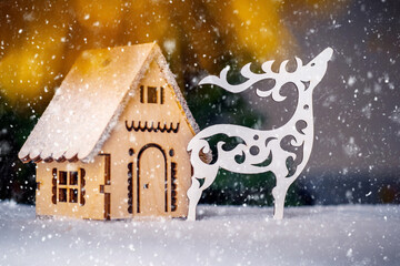 Carved out of wood reindeer and a house for decorating a Christmas tree
