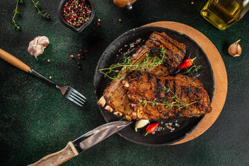 Grilled meat, mutton, lamb rack on a dark background. top view. copy space for text