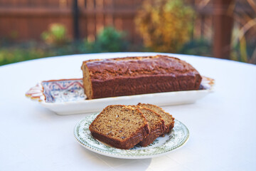 Tasty and delicious banana bread, rich of fiber and with balanced nutritions served outside in the garden of hand crafted village cake shop. Ideal breakfast dish for low carb diet or healthy lifestyle