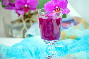 Fruit smoothie and orchid flowers on the table.